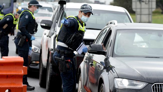 Police check cars at the Little River checkpoint heading out of Melbourne. Picture: Andrew Henshaw