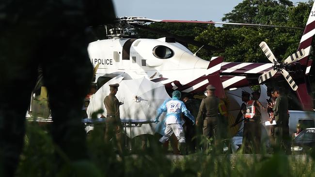 Medical personnel takes a stretcher to a helicopter at a military airport in Chiang Rai. Picture: AFP.