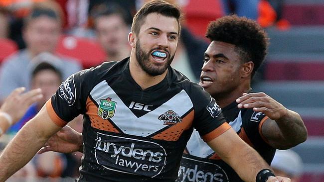 Tigers James Tedesco celebrates scoring a try during the round 6 NRL game between the Newcastle Knights and the Wests Tigers at Hunter Stadium , Newcastle .Picture Gregg Porteous