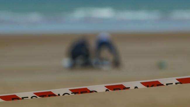 Police and emergency services attend the scene of a body discovered on Casuarina Beach by Dog walkers this week. Picture Glenn Campbell