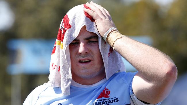 Waratah's Joseph Dillon soaks up the bcoll during a water break in the hot conditions. Picture: John Appleyard