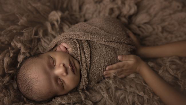 Aavash Wagle is held by his sister. Picture: Georgia Photography