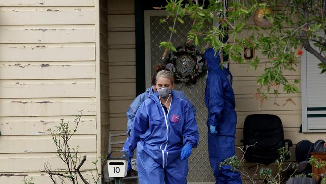 Forensic investigators search a property near the Diec family home in Granville.