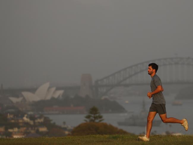 This could be one of the few glimpses of the sun over the next week , forecasters say rain is expected over the next week . People exercise on Dudley page reserve Dover heights .picture John Grainger