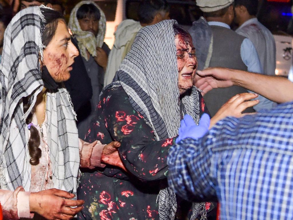 Wounded women arrive at a hospital for treatment after ISIS attacked the Kabil airport, killing more than 100 people. Picture: AFP