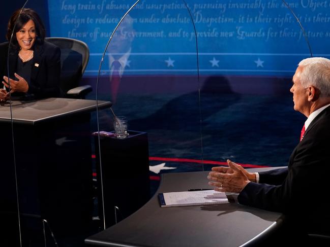 Mike Pence listens and Kamala Harris during the vice presidential debate. Picture: AFP.