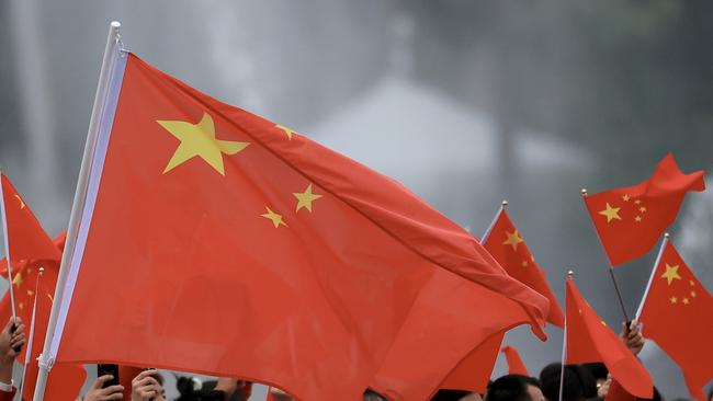 PARIS, FRANCE - JULY 26: Yu Feng and Long Ma, Flagbearers of Team PeopleÃ¢â¬â¢s Republic of China, wave their flag on the team boat along the River Seine during the opening ceremony of the Olympic Games Paris 2024 on July 26, 2024 in Paris, France. (Photo by Maja Hitij/Getty Images)