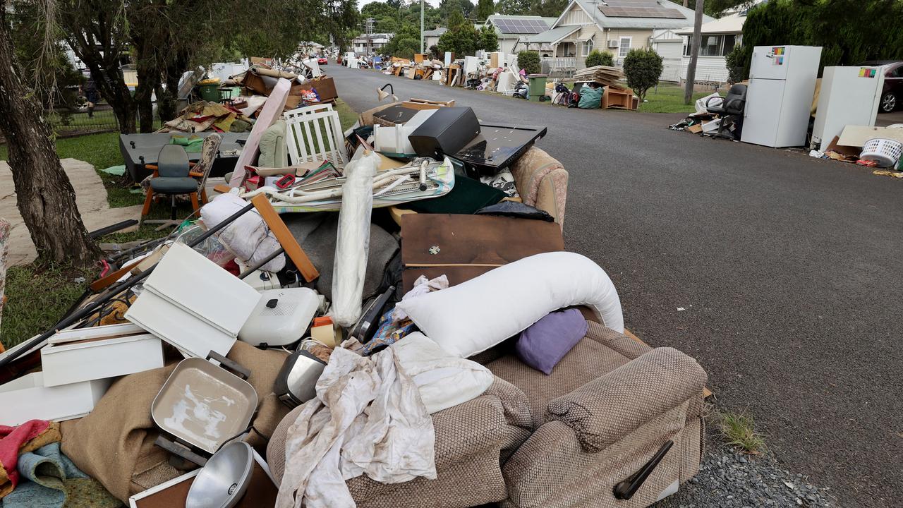 Flood damaged household furniture and appliances are piled up on Garrard St, in the Lismore suburb of Girards Hill. Picture: Toby Zerna