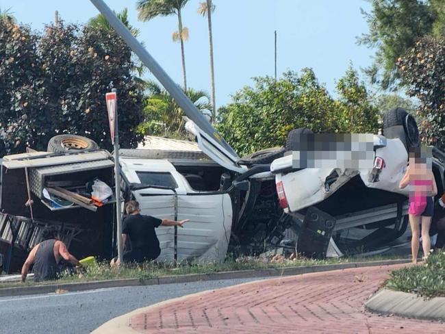 Emergency crews were called following a two-vehicle crash into a power pole at Paget that caused car to roll onto its roof.