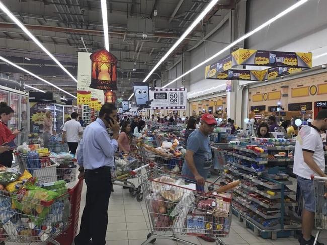 Shoppers stock up on supplies at a supermarket in Doha, Qatar on Monday. Picture: Doha News via AP