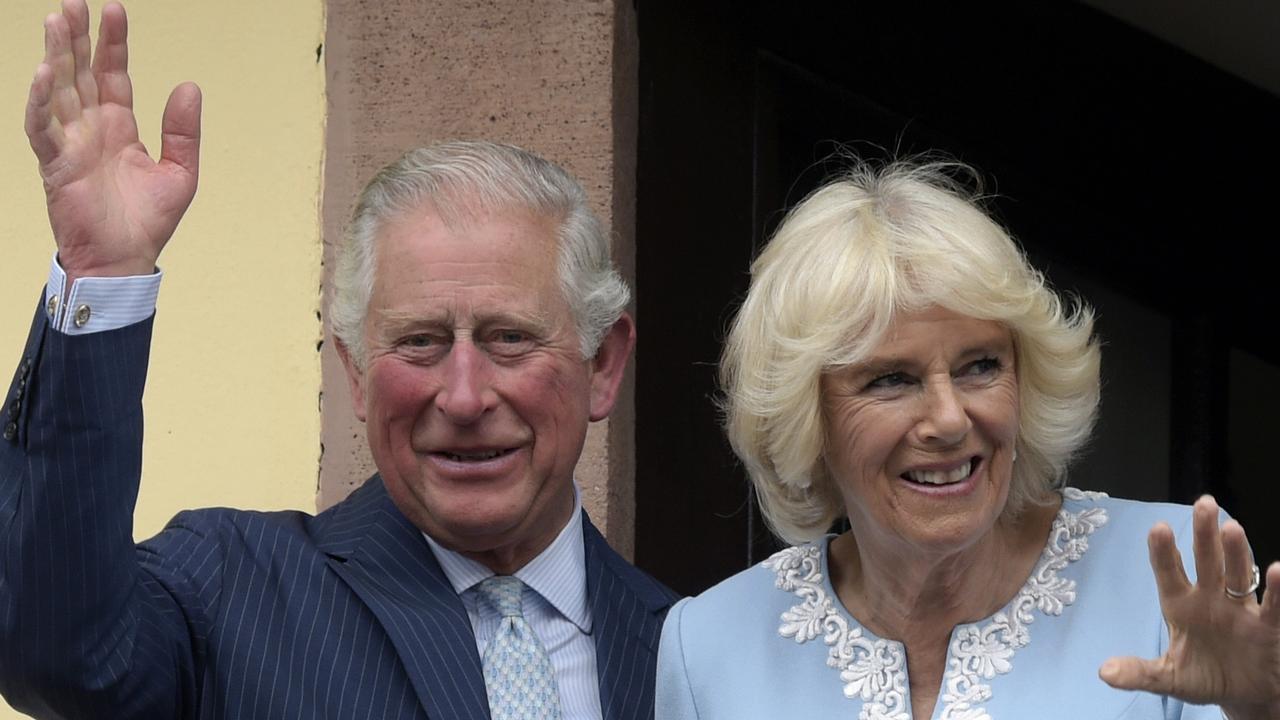 Britain's Prince Charles and Camilla, Duchess of Cornwall wave from the town hall balcony in Leipzig, Germany. Prince Charles has tested positive for the coronavirus. AP Photo/Jens Meyer.