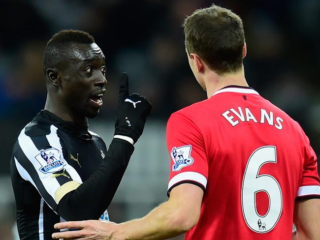 NEWCASTLE UPON TYNE, ENGLAND - MARCH 04: Manchester United player Jonny Evans (r) looks on as Papiss Cisse of Newcastle has words during the Barclays Premier League match between Newcastle United and Manchester United at St James' Park on March 4, 2015 in Newcastle upon Tyne, England. (Photo by Stu Forster/Getty Images)