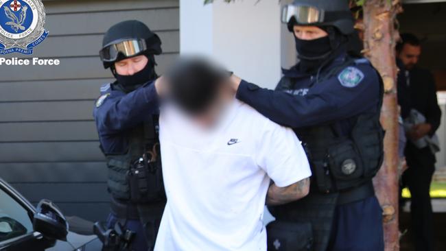 One of the two men being re-arrested. Picture: NSW Police