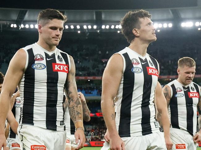 MELBOURNE, AUSTRALIA - APRIL 25: The Magpies leave the field after a draw during the 2024 AFL Round 07 match between the Essendon Bombers and the Collingwood Magpies at the Melbourne Cricket Ground on April 25, 2024 in Melbourne, Australia. (Photo by Dylan Burns/AFL Photos via Getty Images)