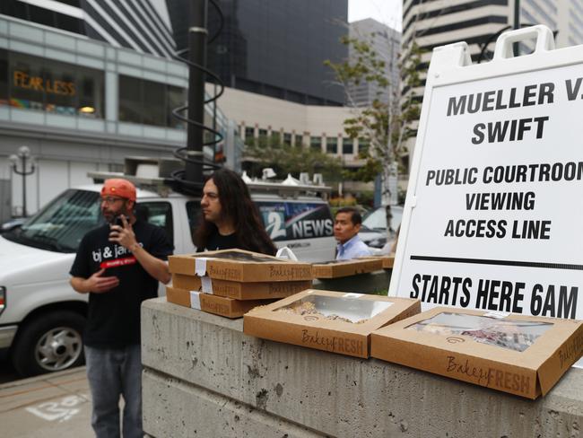 Supplied by a local radio station, boxes of doughnuts sit on a wall for members of the public as they wait to attend the civil trial for pop singer Taylor Swift. Picture: AP