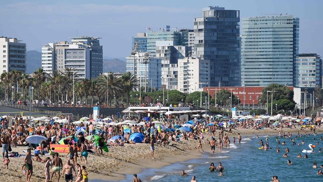 People swim and sunbathe at the Bogatell beach in Barcelona at the end of lockdown. Picture: AFP.