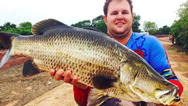 Peter Cooper with another swamp-dog barra that made the journey from the fresh to the brackish salt and hopefully regained its strength