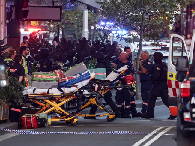 Paramedics push stretchers into the Westfield Bondi Junction shopping mall to retrieve the injured after a the incident on April 13.