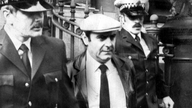 Informer Gianfranco Tizzoni surrounded by police as he leaves NSW Supreme Court in Sydney?? (POSSIBLE MELBOURNE?? VICTORIAN SUPREME COURT)17/09/1984. Tizzoni was involved in the disappearance of Griffith anti-drugs campaigner Donald MacKay.