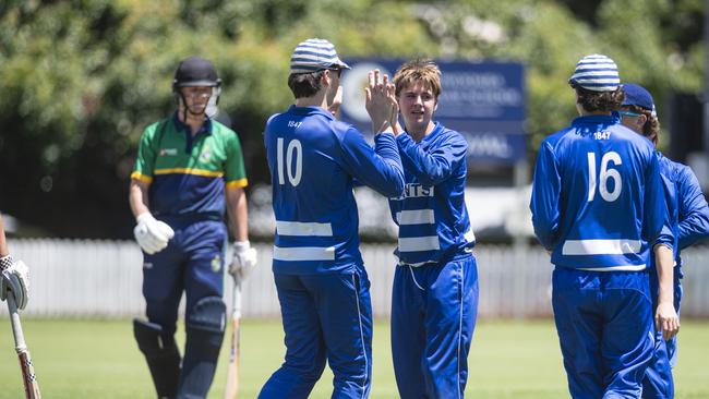 Bowler William Howard (centre) celebrates a dismissal for St Peter’s College against St Kevin’s College.