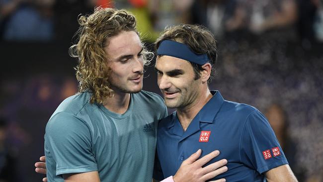 Greece's Stefanos Tsitsipas, left, is congratulated by Switzerland's Roger Federer after winning their fourth round match at the Australian Open tennis championships in Melbourne, Australia, Sunday, Jan. 20, 2019. (AP Photo/Andy Brownbill)