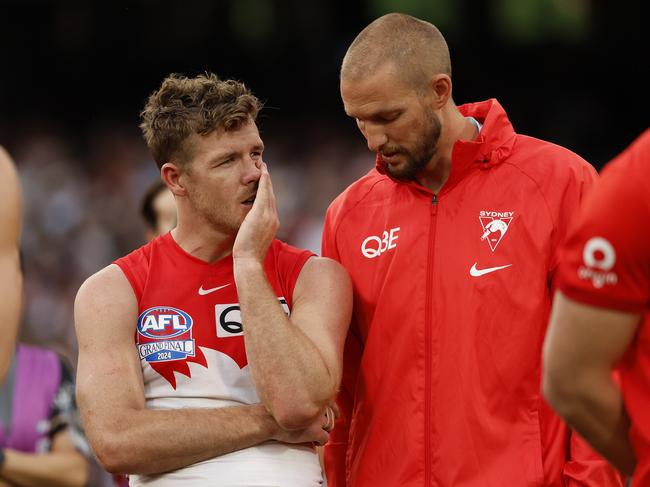 Parker and Reid look on as the Lions lift the 2024 premiership. Picture: Phil Hillyard