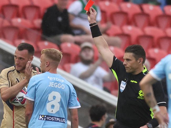 NEWCASTLE, AUSTRALIA - OCTOBER 19: Referee Shaun Evans givs James Jeggo of Melbourne City a red card during the round one A-League Men match between Newcastle Jets and Melbourne City at McDonald Jones Stadium, on October 19, 2024, in Newcastle, Australia. (Photo by Scott Gardiner/Getty Images)