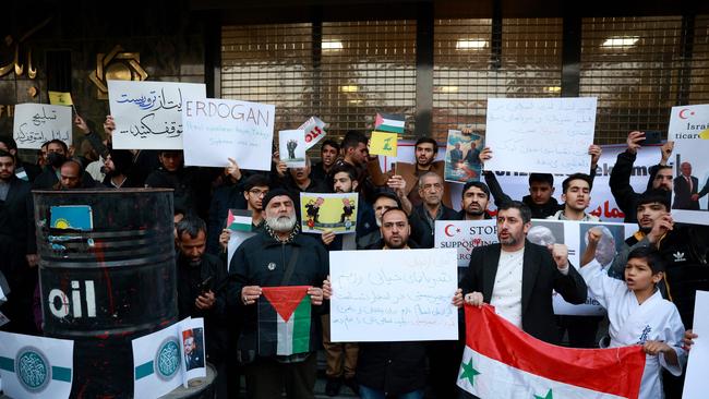 Iranians chant slogans and hold Syrian and Palestinian national flags during a protest in front of the Turkish embassy against Turkey's support of an Islamist-dominated rebel alliance battling the regime in Syria. Picture: Getty