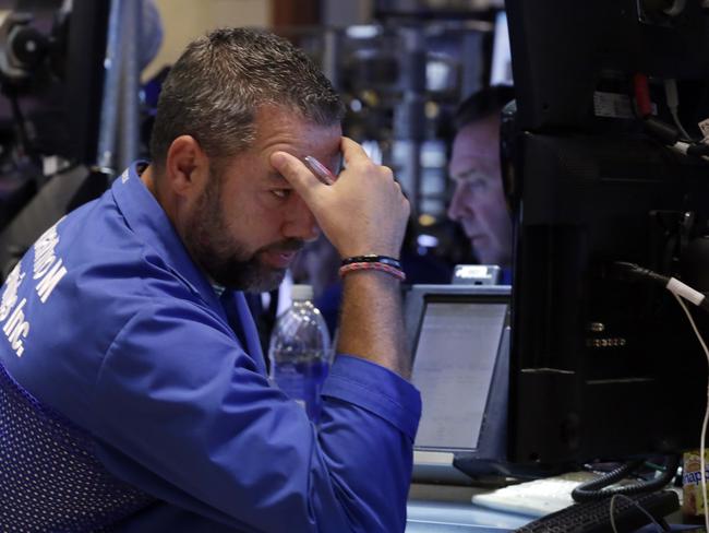 Trader Kevin Lodewick works on the floor of the New York Stock Exchange, looks on in disbelief. Friday, Aug. 21, 2015.