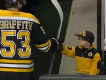 Adorable kid fist bumps entire team