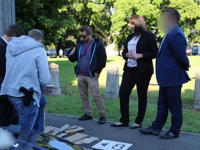 A Current Affair senior report Ben McCormack waited on the side of the road with detectives as they searched his car. Picture: NSW Police.