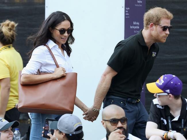 Prince Harry and Meghan Markle hold hands as they walk through the crowd. Picture: Chris Jackson/Getty Images for the Invictus Games Foundation