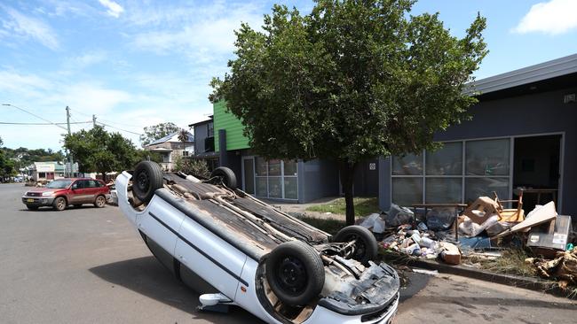 An overturned car on Dawson St, Lismore in the aftermath of the 2022 floods. Picture: Jason O'Brien