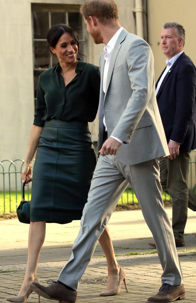 Baby clue? The Duchess wore a green leather skirt, showing a small bump, during her tour of Sussex.