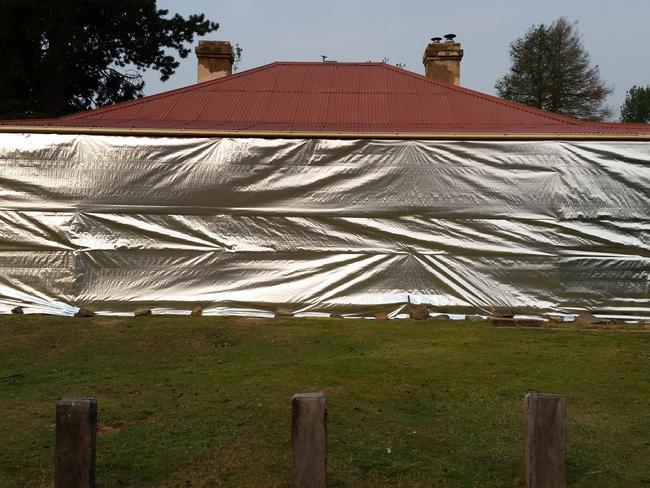 Wrapping properties in foil is one approach the NPWS is adopting to protect historic properties including Currango Homestead from bushfire.