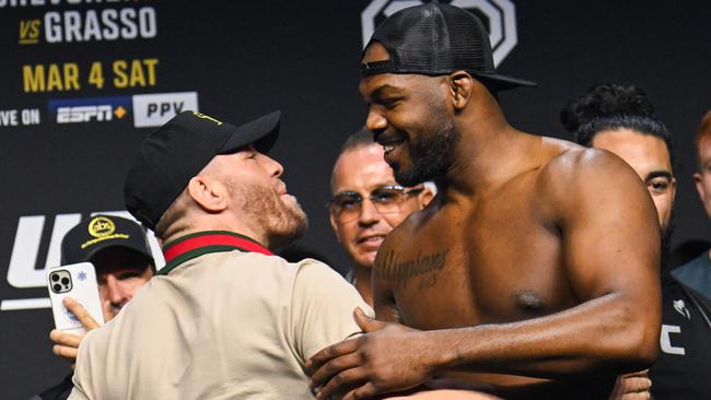 Jon Jones greets Conor McGregor during the ceremonial weigh-in ahead of UFC 285.(Photo by Patrick T. Fallon / AFP)