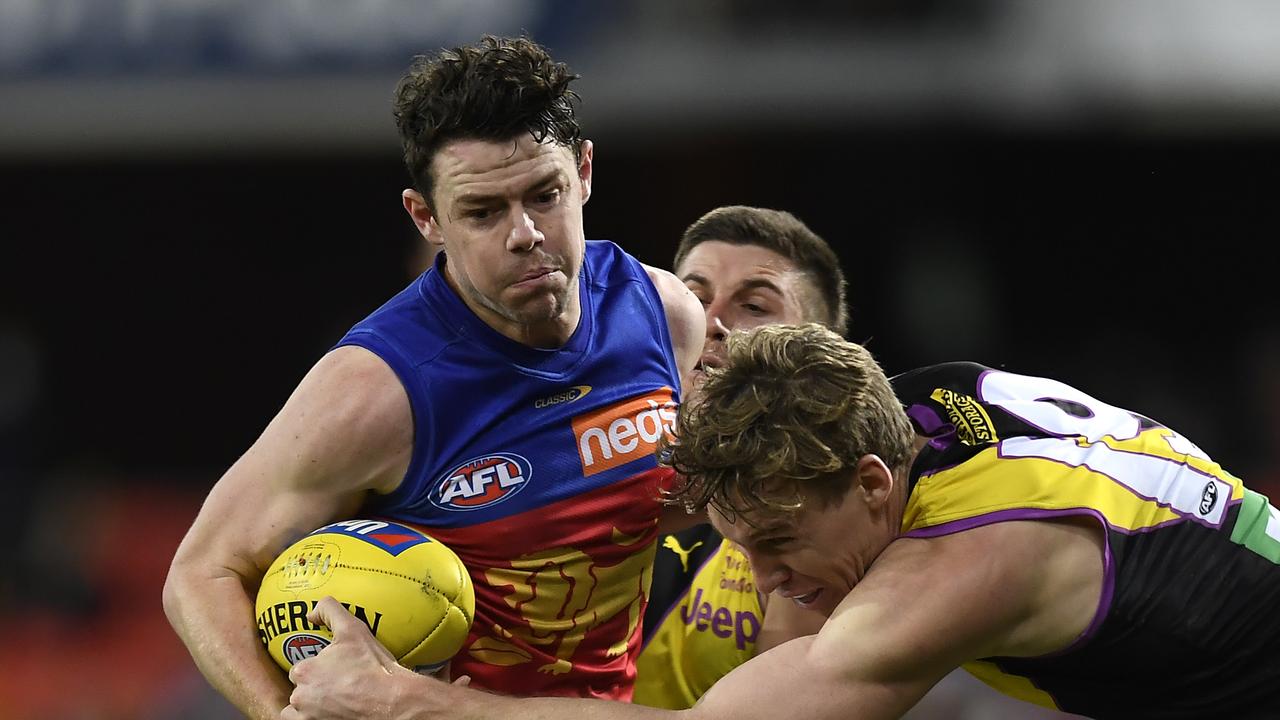 Lachie Neale of the Lions is tackled by Tom Lynch. Picture: Getty Images