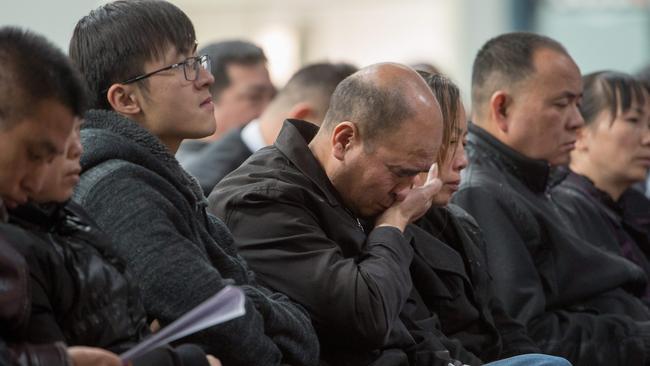 Father and husband, Zheng Quan Yuan and son Jake at the funeral for 14-year-old Xinyu Yuan and her mother Mei-Li Dai, who were killed in a horrific car crash outside Lighthouse Christian College. Picture Jay Town