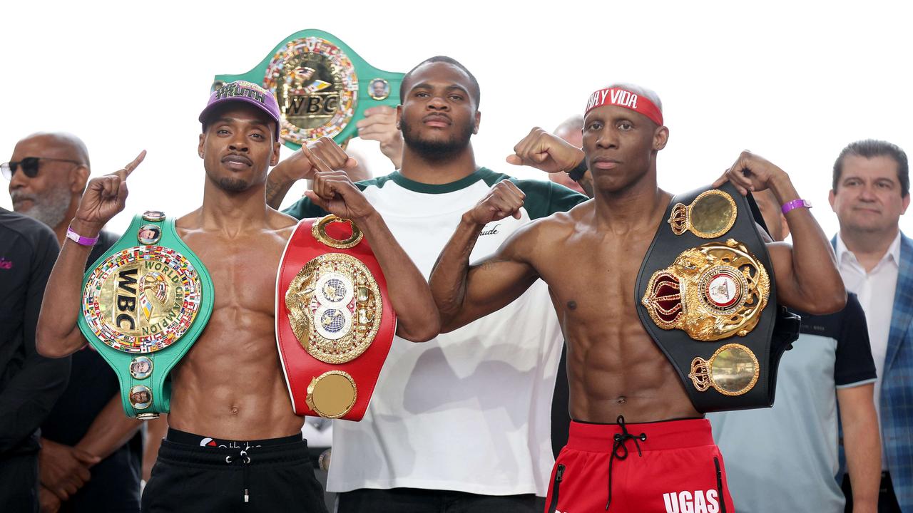 ARLINGTON, TEXAS - APRIL 15: (L-R) Errol Spence Jr. and Yordenis Ugas pose with Dallas Cowboys linebacker Micah Parsons (center) during the official weigh-in at Texas Live! on April 15, 2022 in Arlington, Texas. Tom Pennington/Getty Images/AFP == FOR NEWSPAPERS, INTERNET, TELCOS &amp; TELEVISION USE ONLY ==