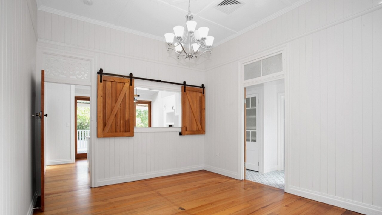 The home has high ceilings and gorgeous light fittings as well as a barn-door servery window.
