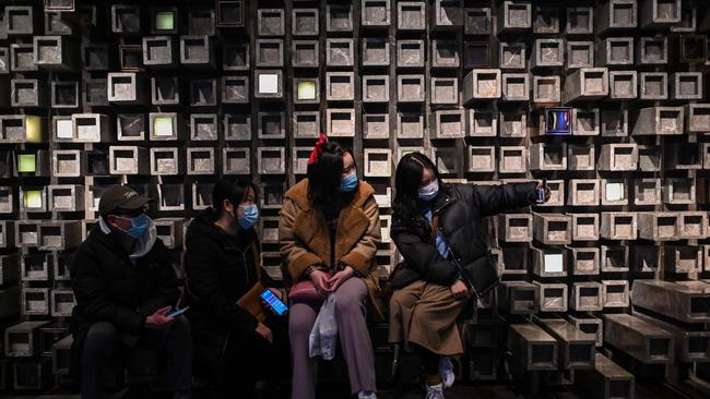 People take a selfie in a shopping mall in Wuhan.. Picture: AFP