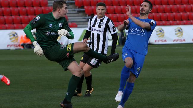 Adelaide City gloveman Joe Gauci has signed for Melbourne City. Gauci in action during this year’s FFA Cup SA final 3-2 loss to Adelaide Olympic at Hindmarsh Coopers Stadium. The goalkeeper is being closed down by Olympic’s Fausto Erba. (AAP/Emma Brasier)