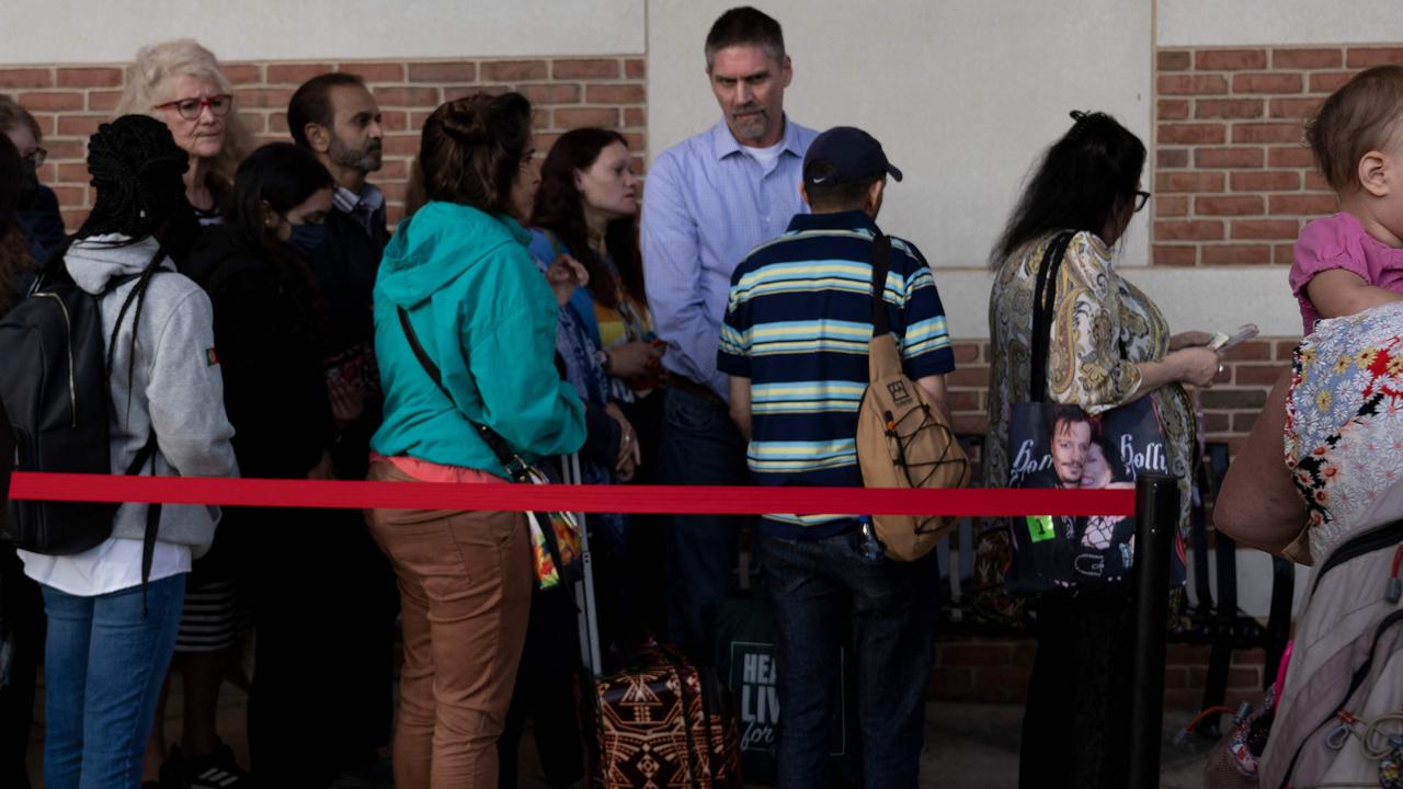 People waiting in line to get a pass to enter the court during the final week of the defamation trial. Picture: Brendan Smialowski / AFP