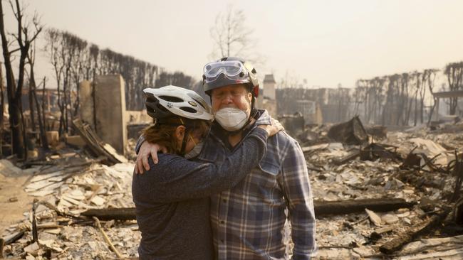 Claudio and Kathleen Boltiansky embrace in their fire-ravaged neighbourhood after the Palisades fire swept through the neighbourhood. Picture: AP