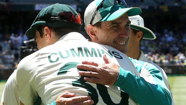 Langer and captain Pat Cummins hug each other after Australia retained the Ashes. Picture: AFP