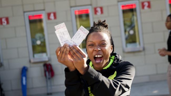 A woman cheers after receiving tickets to Muhammad Ali's memorial service.