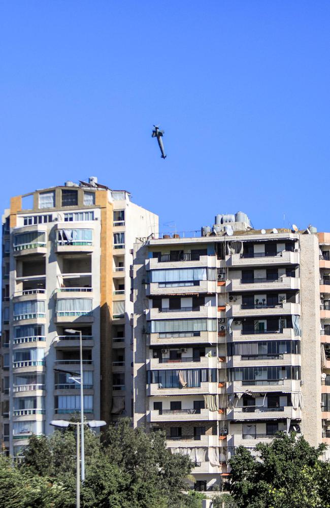 A rocket fired by an Israeli war plane approaches a building in Beirut's southern suburb of Shayah. Picture: AFP