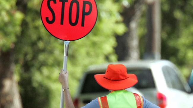 04 Feb 2005 Lollipop Lady with "Stop" sign at crossing at Kedron State School, Lemkie Road.. PicCampbell/Scott  road safety School Crossing Supervisor