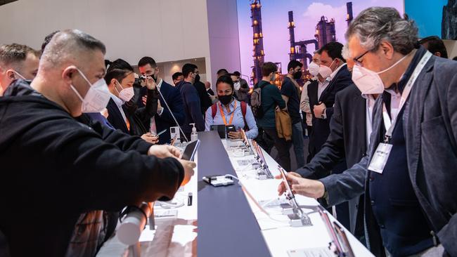 Visitors check mobile devices on day one of the GSMA Mobile World Congress in Barcelona. Picture: Getty Images