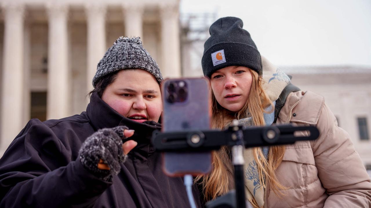 Content creators Callie Goodwin (left) and Sarah Baus speak to a live stream audience outside the Supreme Court Building. Picture: Andrew Harnik/Getty Images/AFP